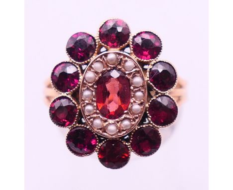 A 9 ct gold, garnet and seed pearl ring. Ring size P. 