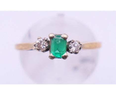 A 9 ct gold, emerald and diamond ring. Ring size N. 