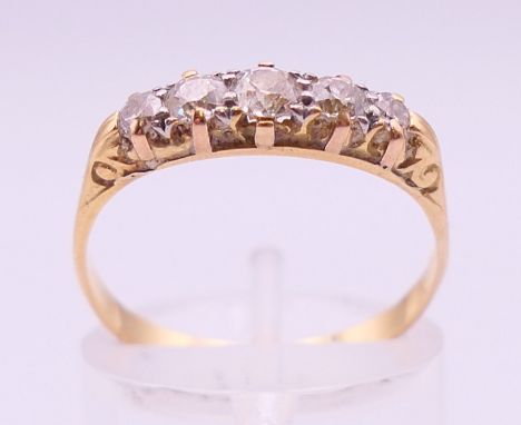 An 18 ct gold five-stone diamond ring. Ring size P/Q. 