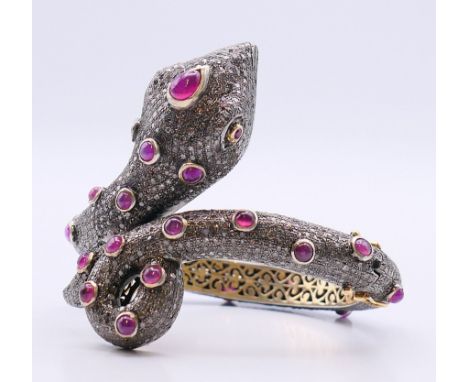 A diamond snake bangle.  5.5 cm internal diameter, 7.25 cm external diameter, snake head and tail scroll 6 cm high. 