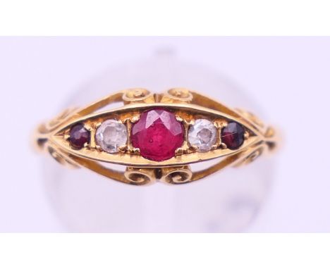 An 18 ct gold, diamond and ruby ring. Ring size N/O. 