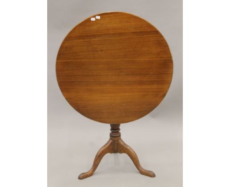 A George III oak tilt-top tripod table. 75 cm diameter.