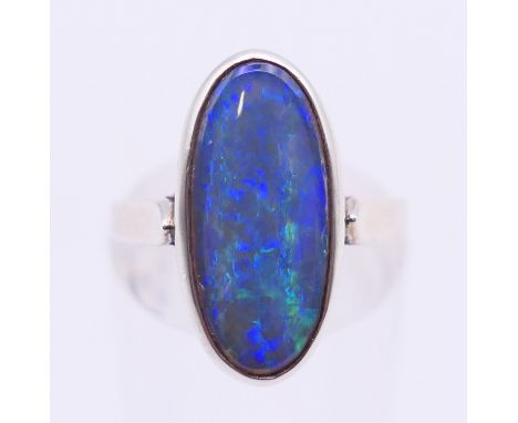 An Australian black opal ring set in silver. Ring size L/M. 