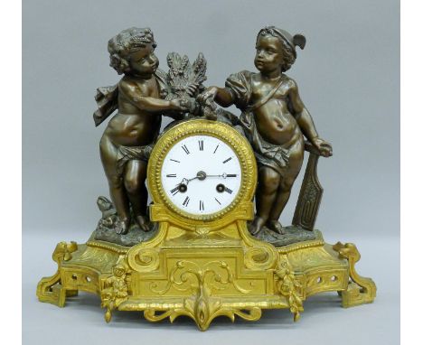 A 19th century mantle clock surmounted with bronzed spelter putti. 31 cm high.