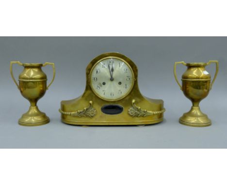A brass mantle clock and a pair of vases. The former 27.5 cm high.