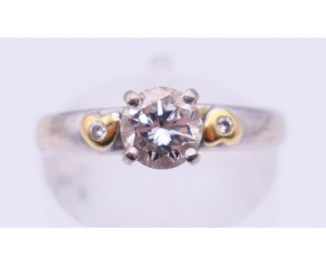 An 18 ct white gold three stone diamond ring. Ring size M. 