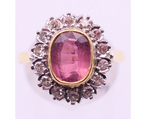 An 18 ct gold, diamond and pink stone ring. Ring size P/Q.