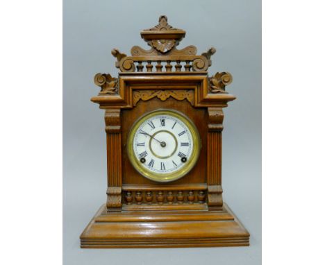 A Victorian walnut mantle clock. 42 cm high.