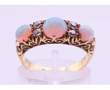 An 18 ct gold, opal and diamond ring, opals estimated weight 1.44 carats, diamonds estimated weight 0.24 carats, gross weight