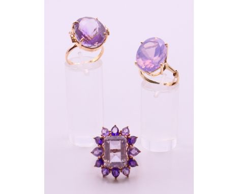 Two 9 ct gold and amethyst rings 13.4 grammes total weight and a 14 ct gold and amethyst ring 8.1 grammes total weight. 