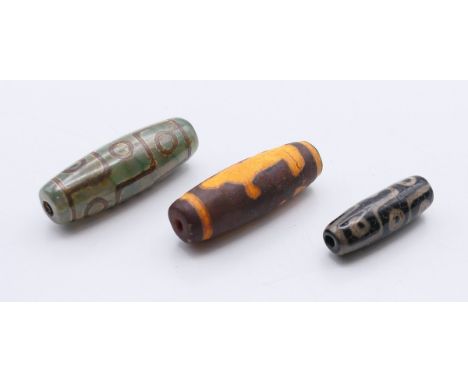 Three agate dzi beads.  4.2 cm, 4 cm and 3 cm high respectively.