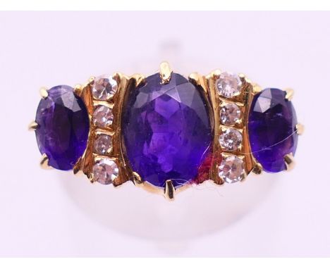An 18 ct gold, diamond and amethyst ring. Ring size O/P.