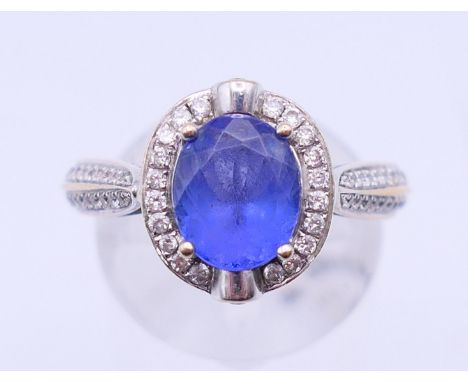 An 18 K white gold, diamond and tanzanite ring, marked D 0.40 and TZ 2.54. Ring size O. 