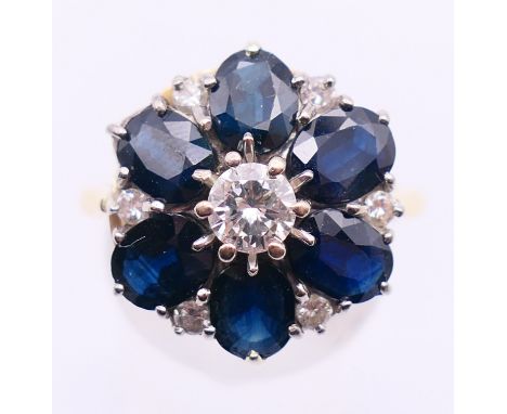An 18 ct gold, diamond and sapphire cluster ring. Ring size N/O.