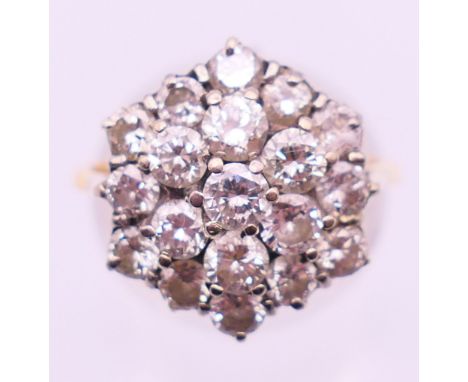An 18 ct gold diamond cluster ring. Ring size P.