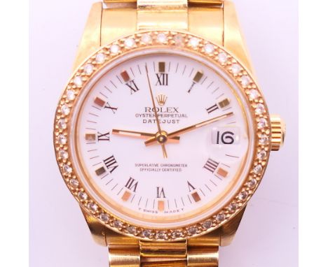 An 18 ct gold Rolex Oyster Perpetual Datejust chronometer wristwatch with associated diamond bezel (original bezel present), 