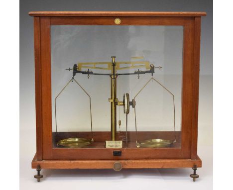 Baird &amp; Tatlock brass balance scales, complete with weights, in fitted mahogany and glass panelled case, 47cm wide x 46cm