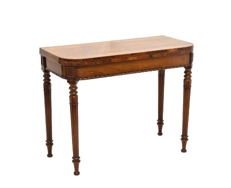 Early 19th century mahogany fold-over card table with moulded decoration, raised on reeded turned supports, 91cm x 45cm (90cm