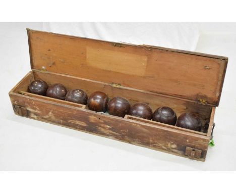 Vintage pine-cased lawn bowls set, comprising two jacks and eight lignum bowls in hinged pine carry case with brass side hand