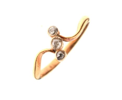 Early 20th century diamond three-stone crossover ring, the yellow metal shank stamped '18ct', size L, 2.5g gross approx