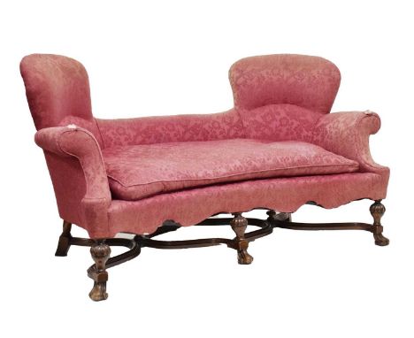 Early 20th century mahogany framed sofa in William and Mary style, the shaped back over scroll arms, squab cushion and concav
