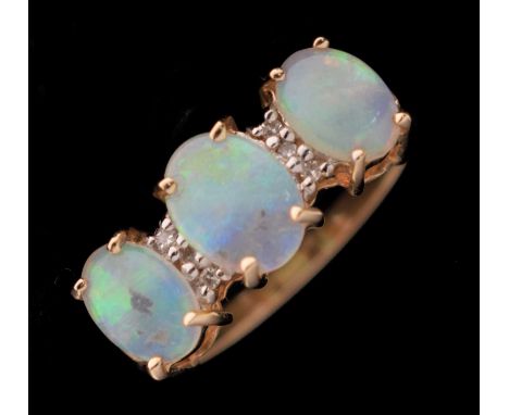 Opal three-stone 14ct gold ring, the three oval opal cabochons with two pairs of white stones in between, size N, 3.6g gross 