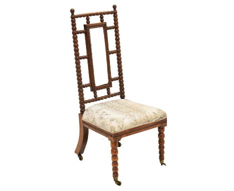 Late 19th century bobbin-turned simulated rosewood over beech nursing chair, upholstered in floral fabric, on bobbin front, a