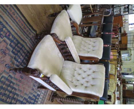 A pair of late Victorian walnut lady's and gent's salon chairs, with button upholstery, moulded supports and spindles to the 