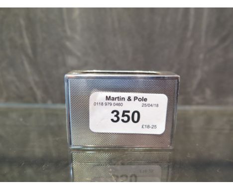 A silver match box cover with engine turned decoration
