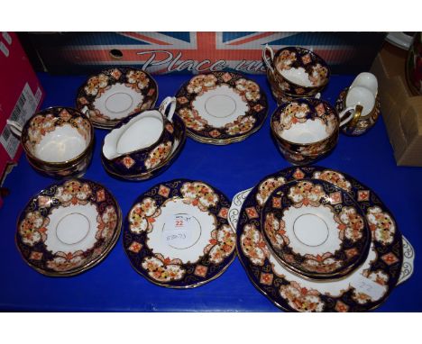 TEA SET IN AN IMARI DESIGN BY ROYAL ALBERT COMPRISING CUPS, SAUCERS, MILK JUG, DERBY STYLE MILK JUG, SANDWICH PLATE ETC