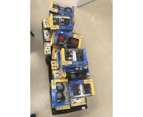 A quantity of boxed Bruder tractor accessories