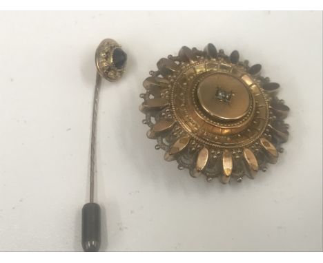 A Victorian gold brooch; together with a garnet stick pin