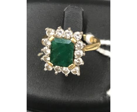 An 18ct diamond and emerald ring