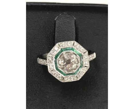 A 0.85ct Art Deco diamond and emerald ring set in 18ct white gold