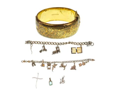 A silver gilt engraved bangle and two silver charm bracelets. The bangle hallmarked Birmingham 1969, total weight 110g.
