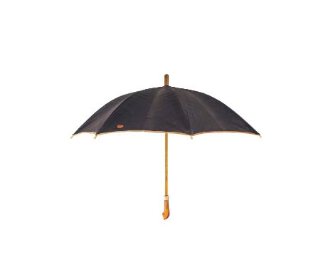 A Christian Dior umbrella. With gold tone collar stamped Christian Dior, leather monogramed label to the canopy, length 74cm.