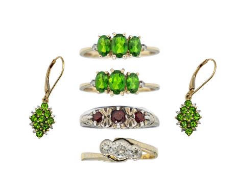 Four gem set rings and a pair of gem-set pendant earrings. One ring is an 18ct and platinum set with three small diamonds, si