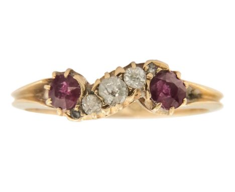 A Victorian 18ct diamond and ruby set five stone ring. Of wavy design claw set with three claw set old cut diamonds, the larg