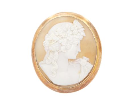 A 9ct rose gold mounted carved shell cameo brooch. The cameo depicting the profile portrait of a Bacchante, the gold mount st