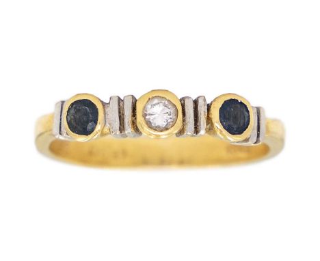 An 18ct diamond and sapphire set three stone ring. The three stones in collet setting, stamped 18k, size K 1/2, 2.5g.