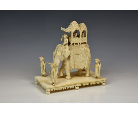 A large Indian carved ivory model of an elephant howdah, mid to late-19th century, modelled with richly carved caparison and 