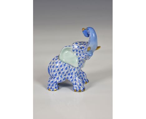 A Herend porcelain Elephant, trunk in air, hand painted in Vieux Herend (VHB) blue fish scale design, trunk and nails in gilt