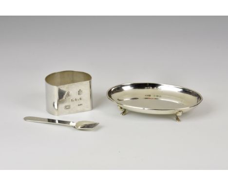 A Bruce Russell Channel Islands silver napkin, date letter for 1988, D-shaped; together with a modern silver salt shovel, Bir