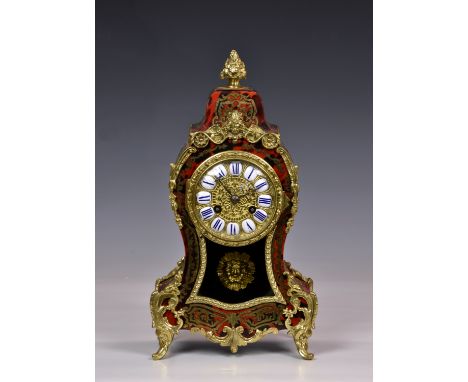 A French boulle work and gilt metal mantel clock, 19th century, the gilt metal dial with inset ceramic Roman Numeral plates, 