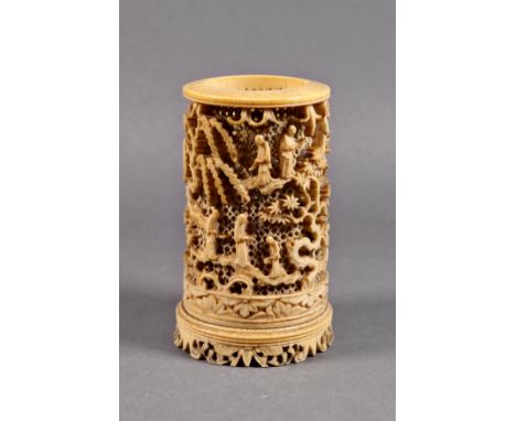 A Chinese carved and pierced ivory brush holder, Qing Dynasty, 18th / early 19th century, the section of tusk pierced and wel