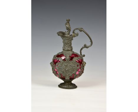 A Dutch style pewter and cranberry glass flagon, late 19th century in the early 18th century style, the flattened, circular g