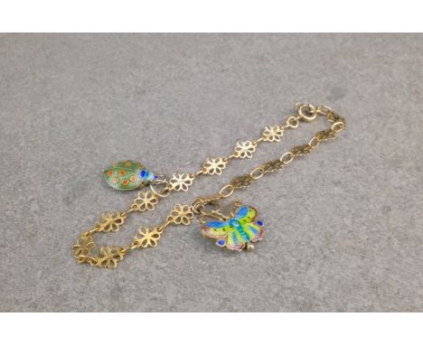 A 9ct gold and enamel charm bracelet, the fancy floral link bracelet suspending two silver gilt and enamel butterfly and lady