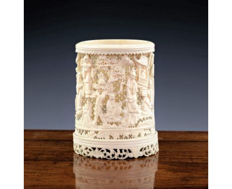 A 19th century Chinese Canton carved and pierced ivory brush pot, carved with figures and buildings in a wooded landscape, ag