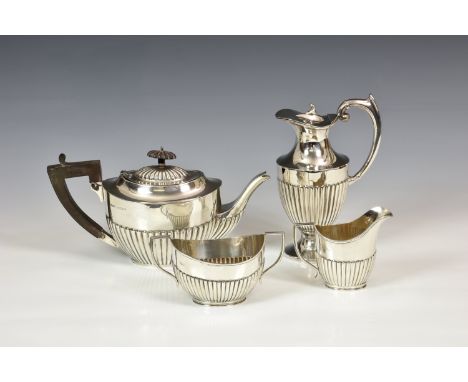 A George V silver three piece tea service, H. V. Pithey &amp; Co., Birm. 1919, oval form with half gadrooned decoration and a