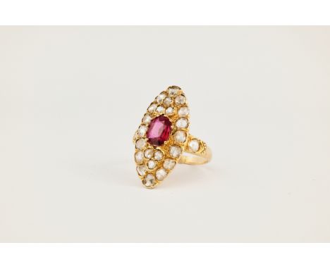 An Art Deco 18ct yellow gold, diamond and ruby navette ring, featuring an oval cut ruby weighing approximately 1.00ct and sur